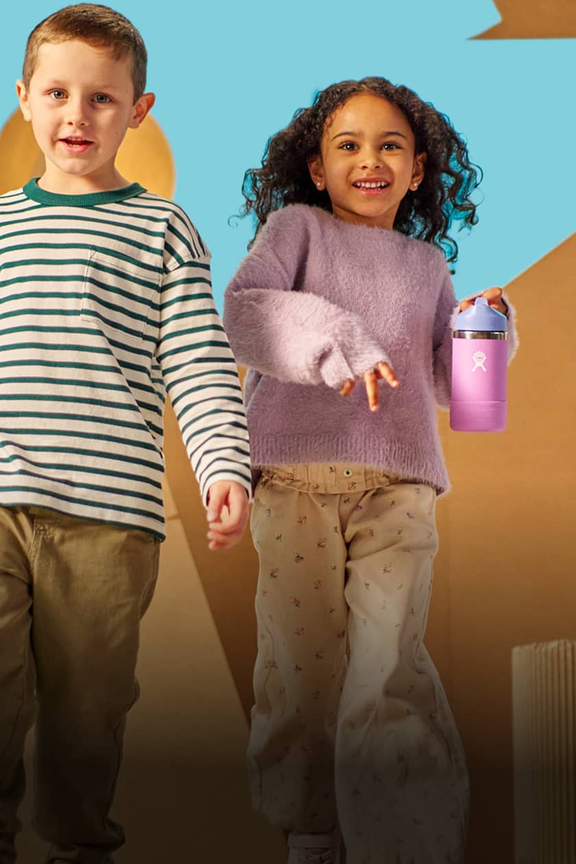 girl and boy walking with hydro flask kids bottles in hand