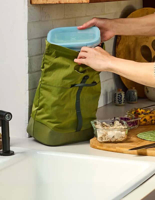 Person packing a Hydro Flask Food Container into a Carryout&trade; Lunch Rolltop in the kitchen