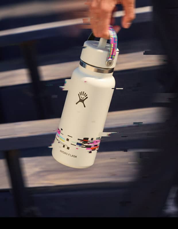 Person holding a Hydro Flask Limited Edition Glitch bottle with a digital glitch streaming through the image